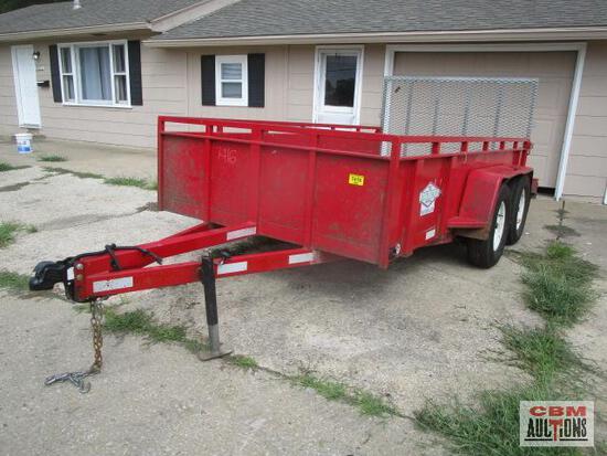 A red trailer is parked in front of a house