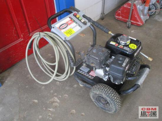 A gas powered pressure washer with a hose attached to it