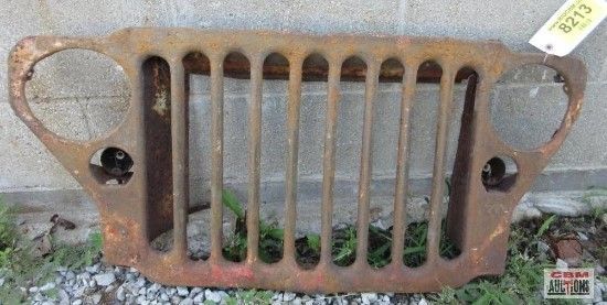 A rusty jeep grill with a tag that says 8213