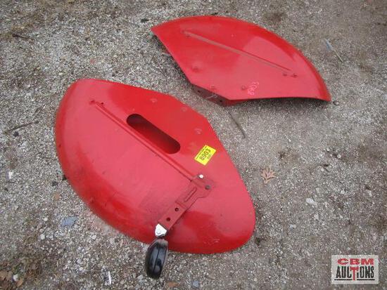 A pair of red fenders are laying on the ground in front of a sign that says gbm auctions