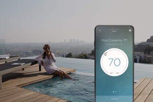 Woman lounging beside a pool with a smartphone displaying 70° pool temperature control