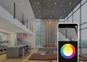 Smartphone app controlling colorful ceiling lights in a modern living room