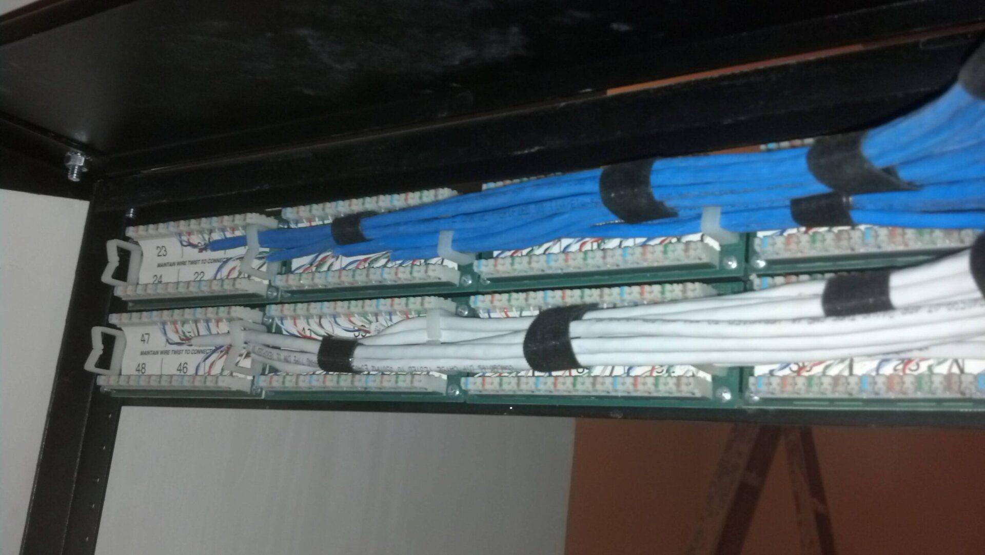 A close-up of stacked circuit boards and wires mounted inside a device.