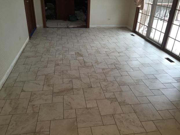 Beige tile floor in a room with a sliding glass door and a doorway.