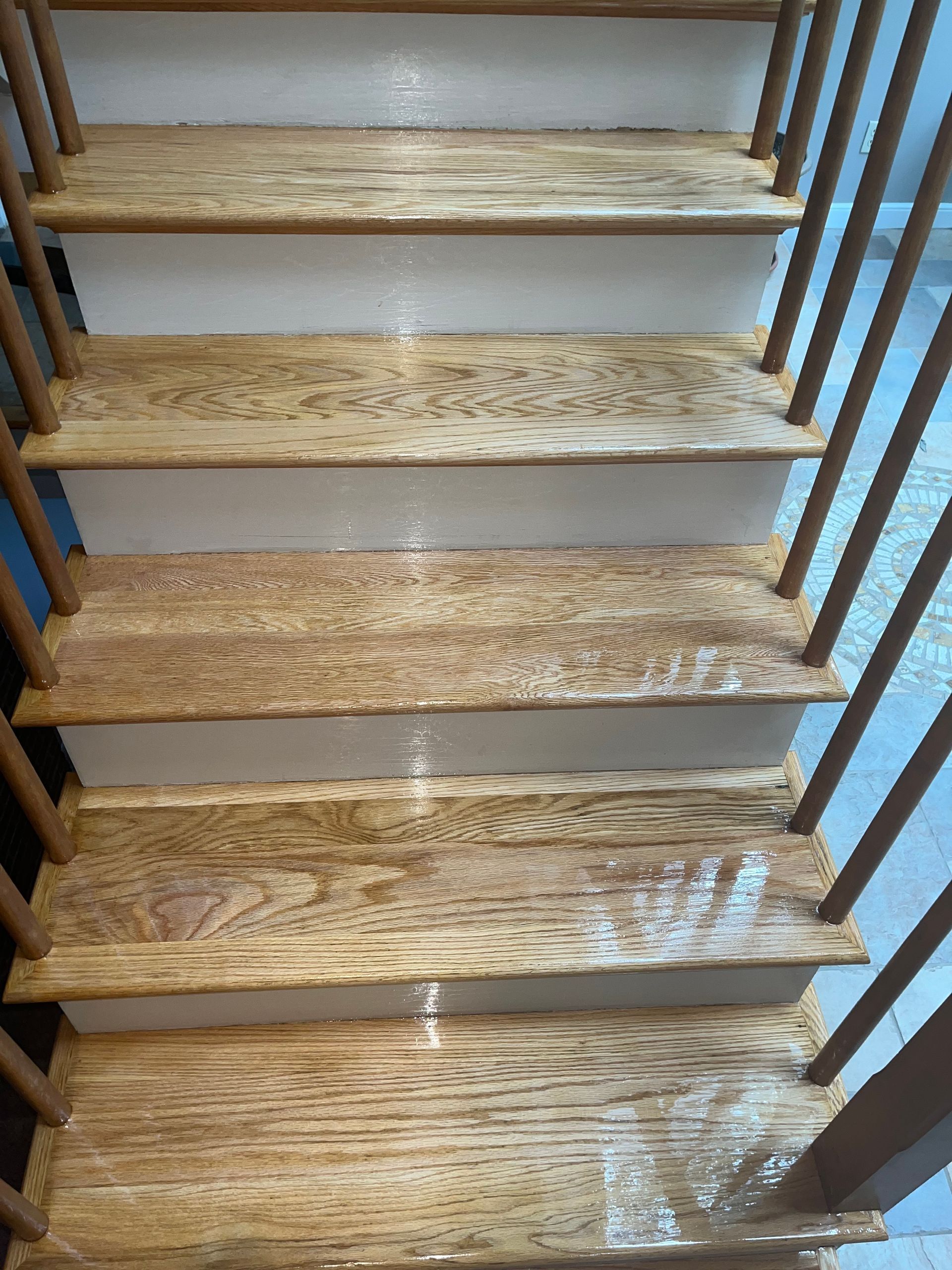 Freshly installed, gleaming hardwood floor in a well-lit room.