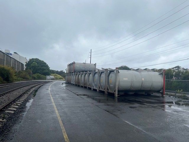 tank containers sitting on side of road