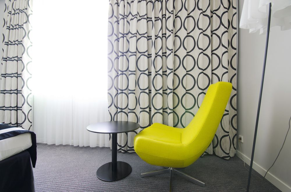 Modern Living Room With Bright Yellow Chair — Original North Australian in Bowen, QLD