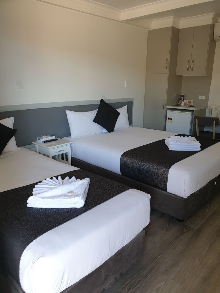 A Hotel Room With Two Beds And A Kitchen — Original North Australian in Bowen, QLD
