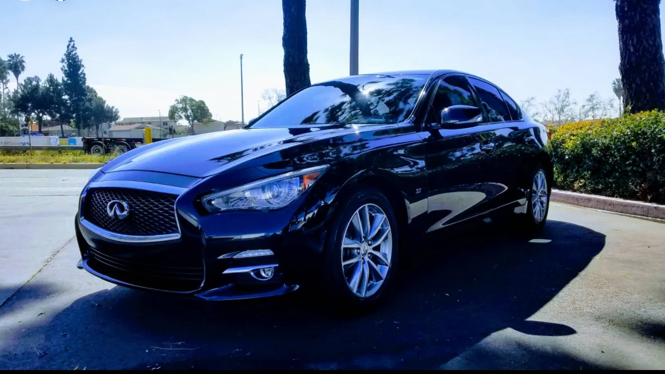 Dark blue Infiniti Q50 parked outside on a sunny day.