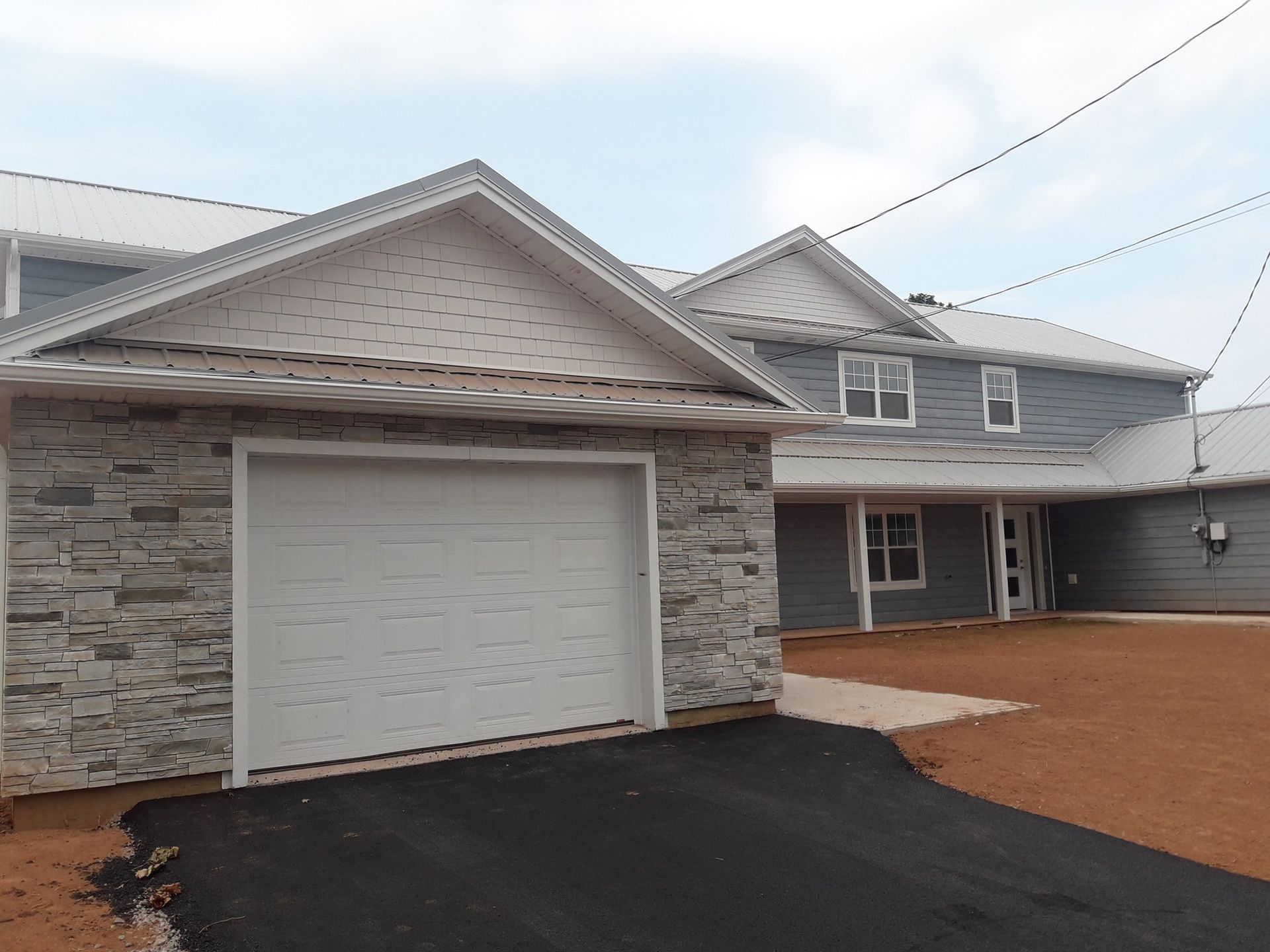 A house with a garage and a driveway in front of it