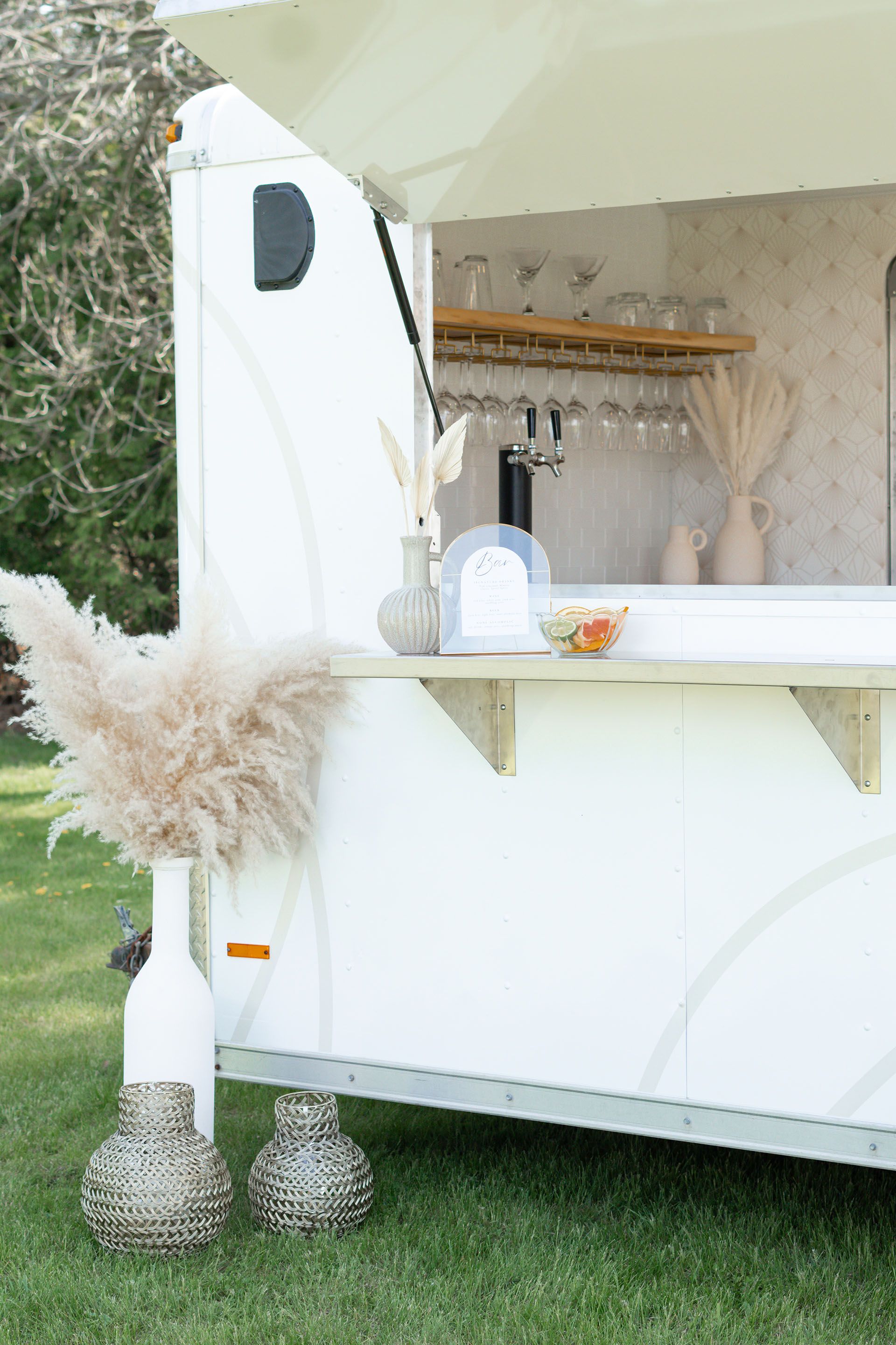 Side view of The Cocktail Cart with cute vases and pampas grass