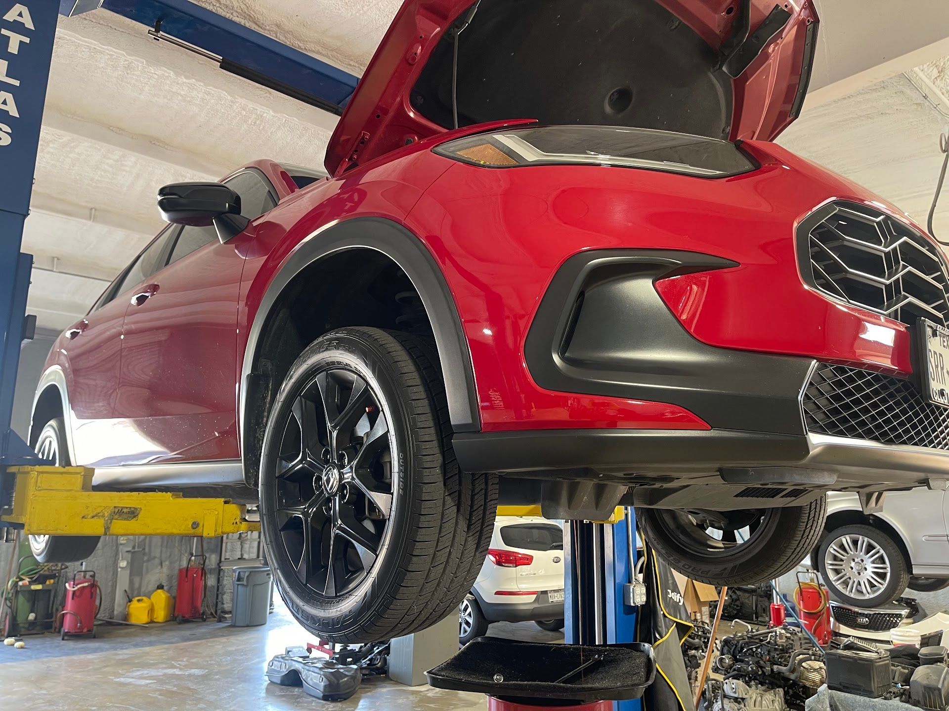 Red Chevrolet SUV Raised on Auto Lift for Repair | L&H Automotive