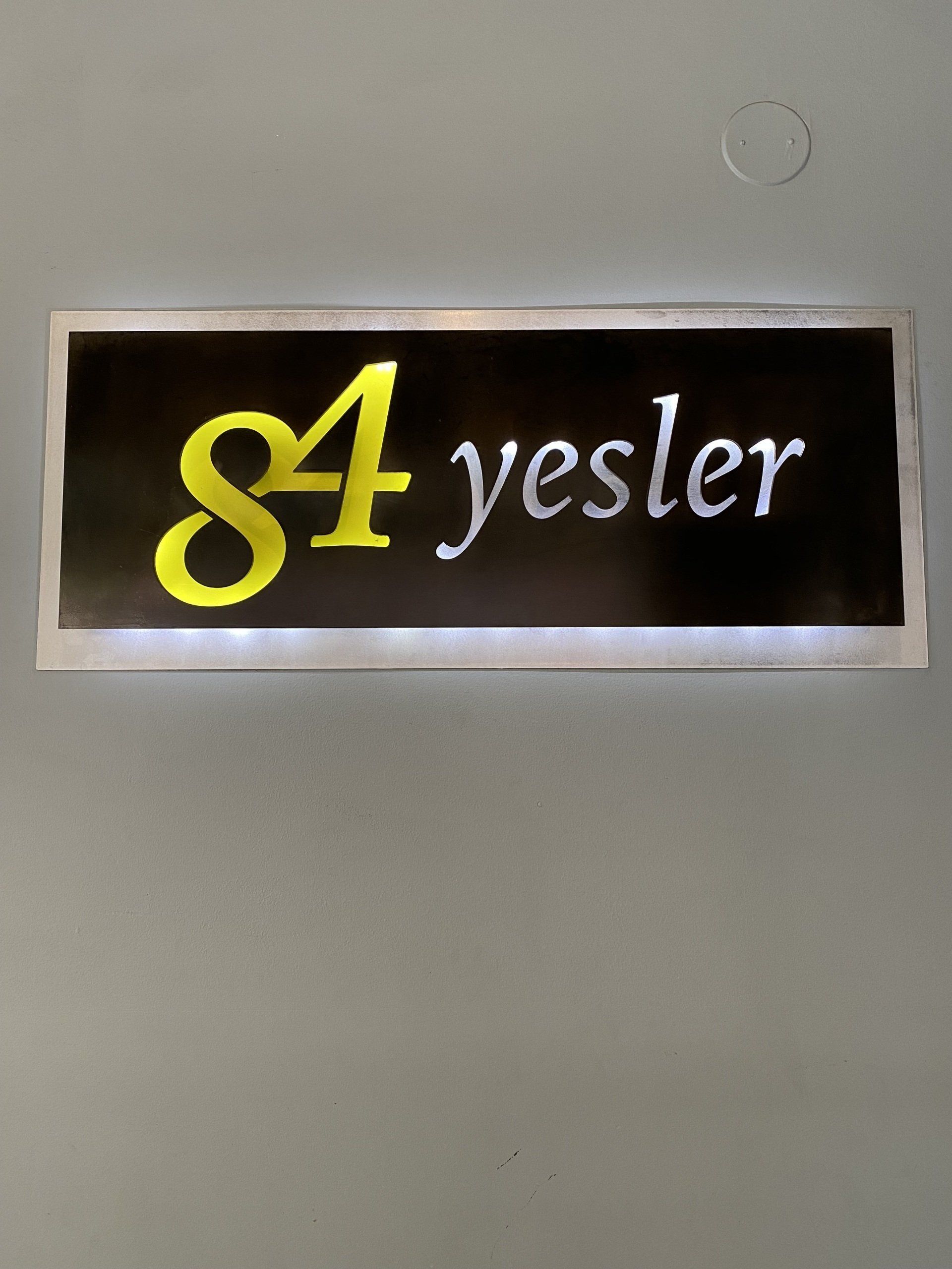A sign on a wall that says 84 yesler