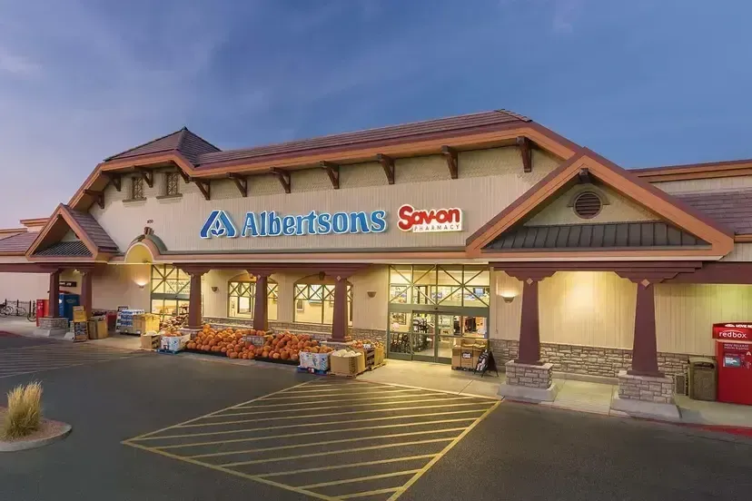 Albertsons Savon grocery store exterior at dusk with lit entrance and parking lot