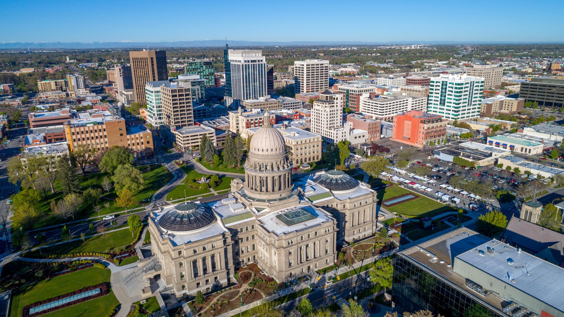 Aerial view of a large domed cathedral and surrounding city blocks on a sunny day