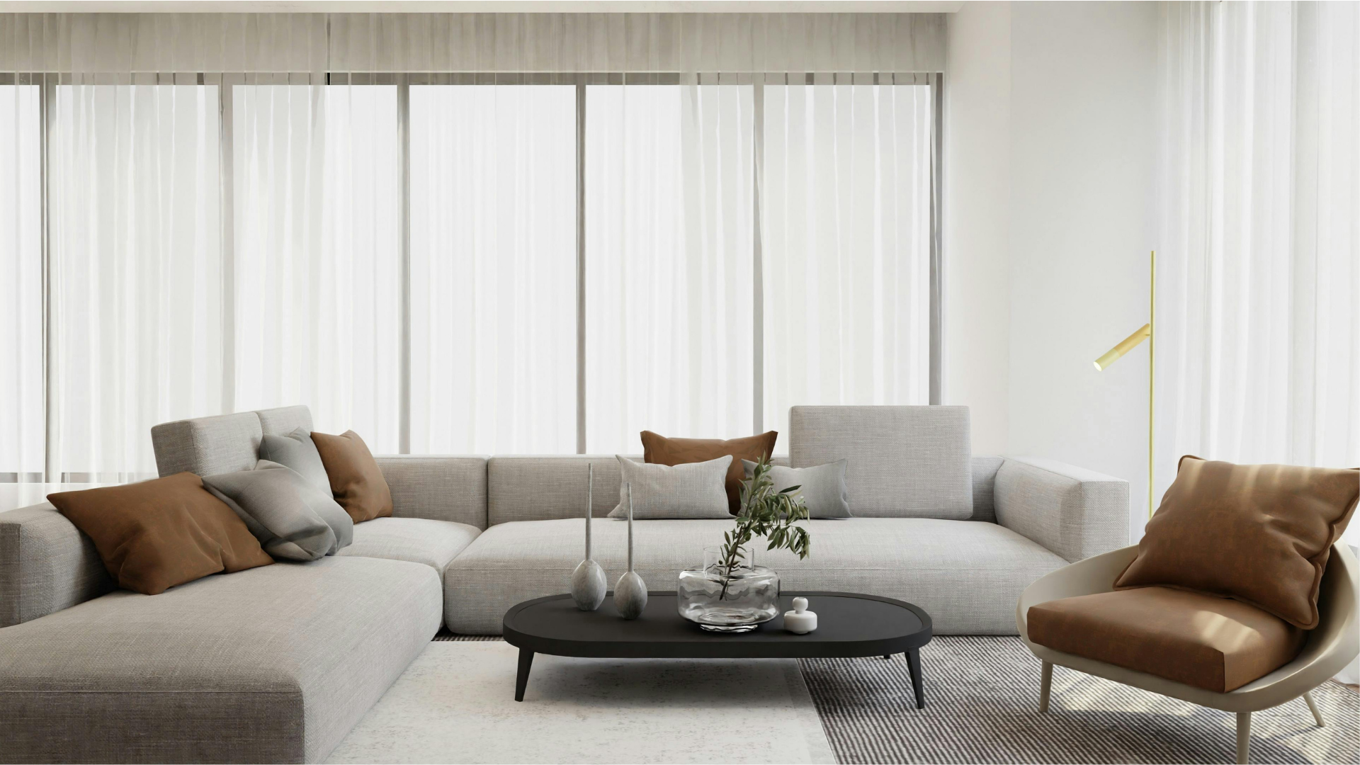 Modern living room with light gray sectional sofa, brown accents, and sheer curtains.