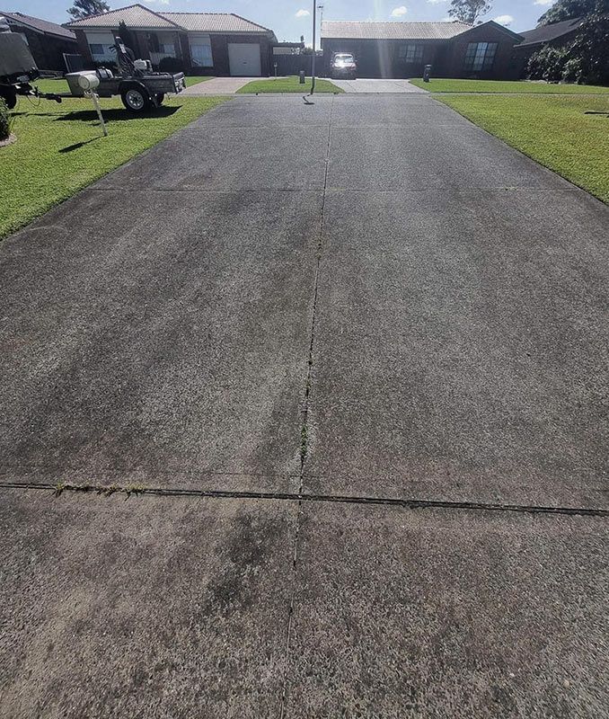 Large Dirty Driveway Before Cleaning — Jervis Bay Pressure Washing & Property Maintenance in Sussex Inlet, NSW