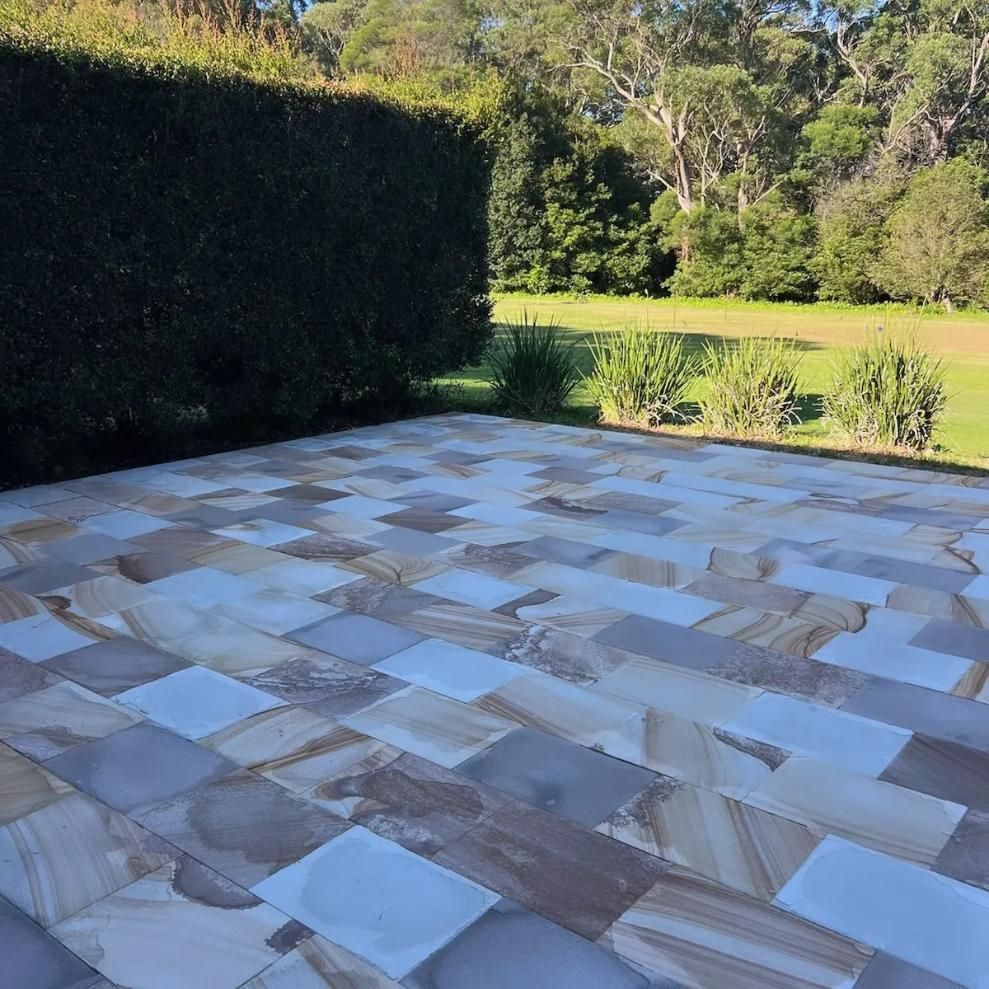 A Patio With A Hedge In The Background Cleaned — Jervis Bay Pressure Washing & Property Maintenance In Tomerong, NSW