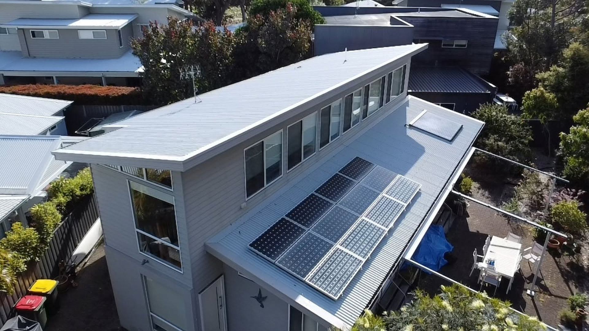 Red Corrugated Roof With Solar Panels — Jervis Bay Pressure Washing & Property Maintenance in Sanctuary Point, NSW