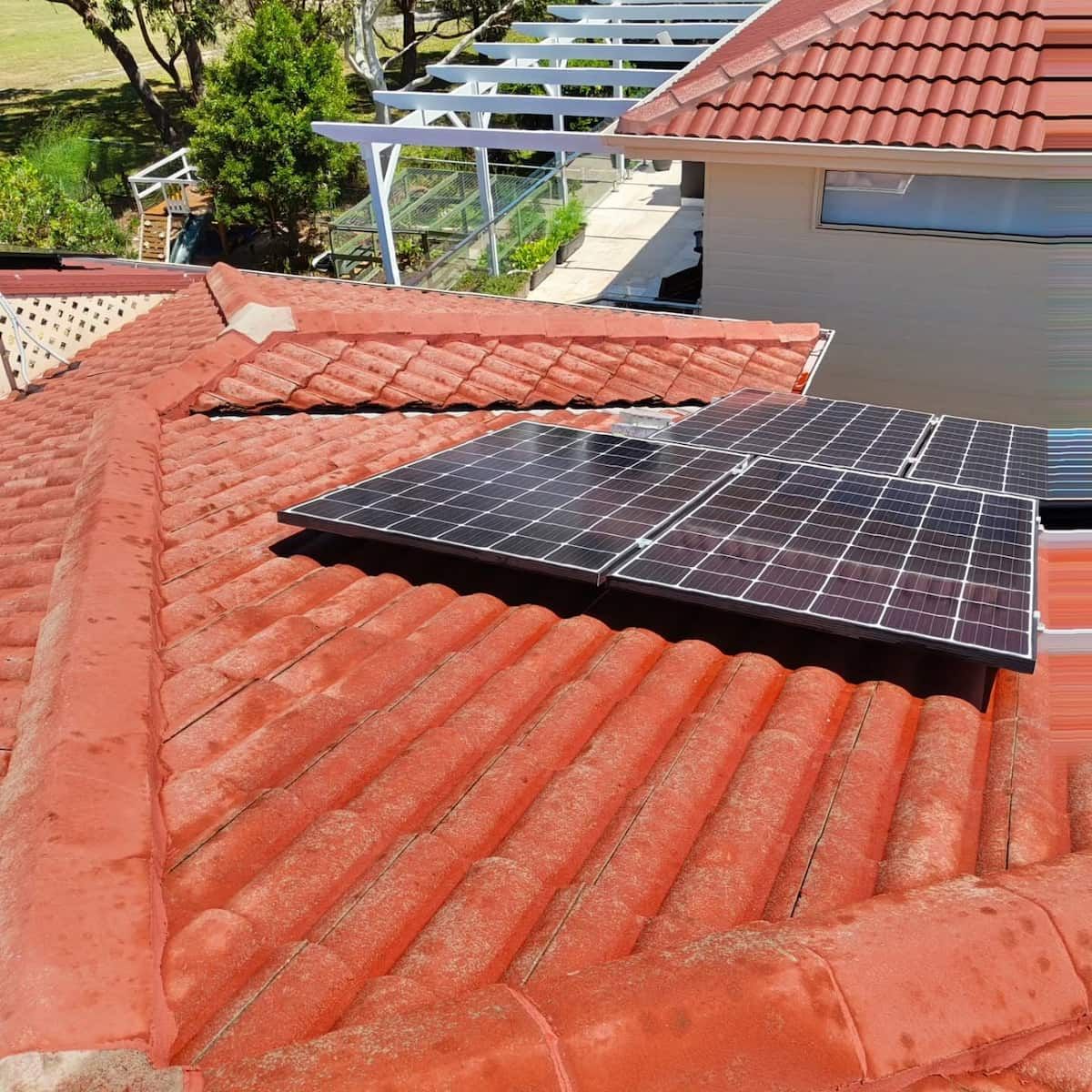 Solar Panel Mounted on a Red Tiled Roof — Jervis Bay Pressure Washing & Property Maintenance in Sanctuary Point, NSW