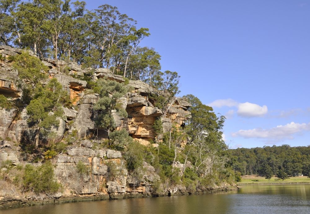 A Cliff Overlooking A Lake With Trees On It — Jervis Bay Pressure Washing & Property Maintenance In Nowra, NSW