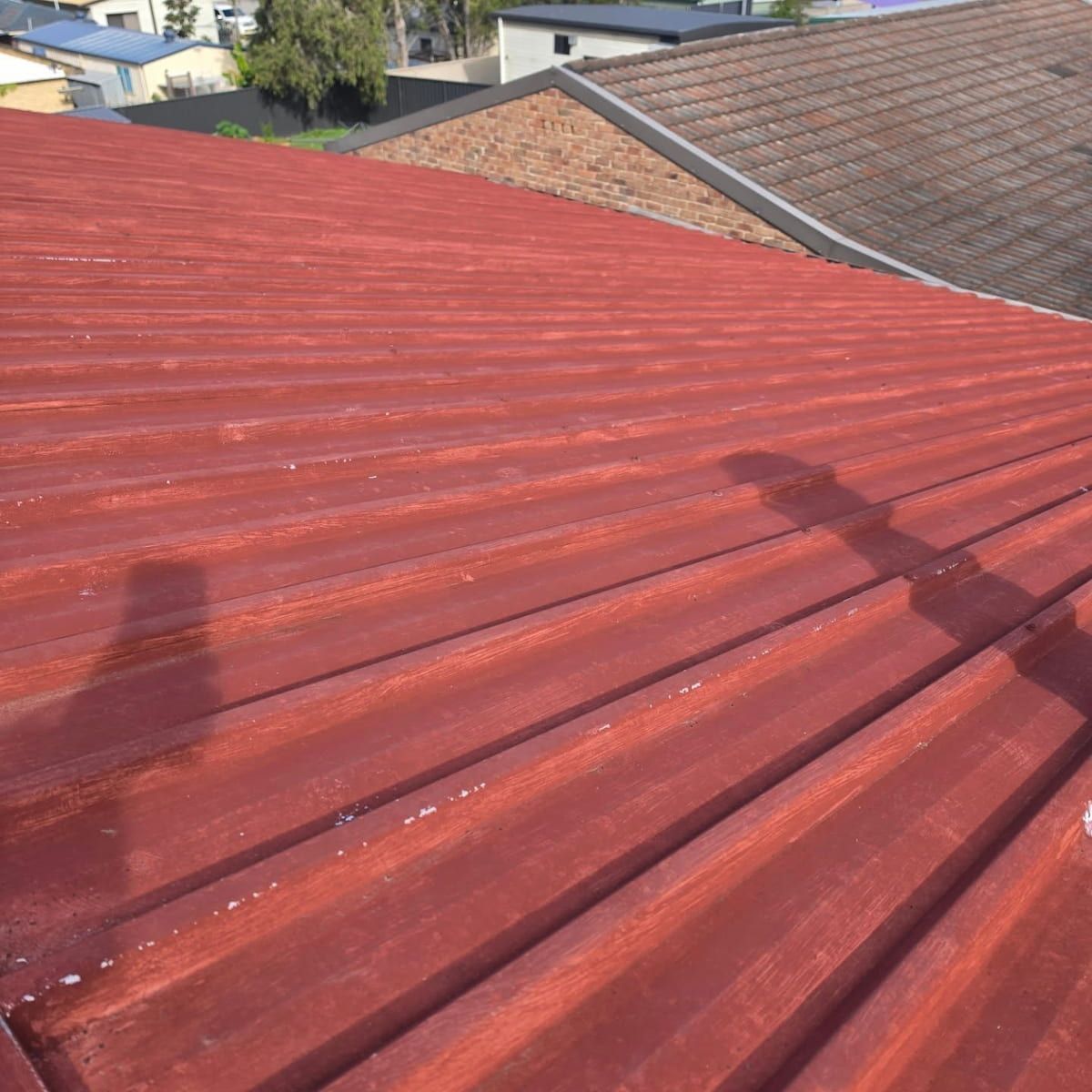 Red Corrugated Metal Roof in Sunlight — Jervis Bay Pressure Washing & Property Maintenance in Sanctuary Point, NSW