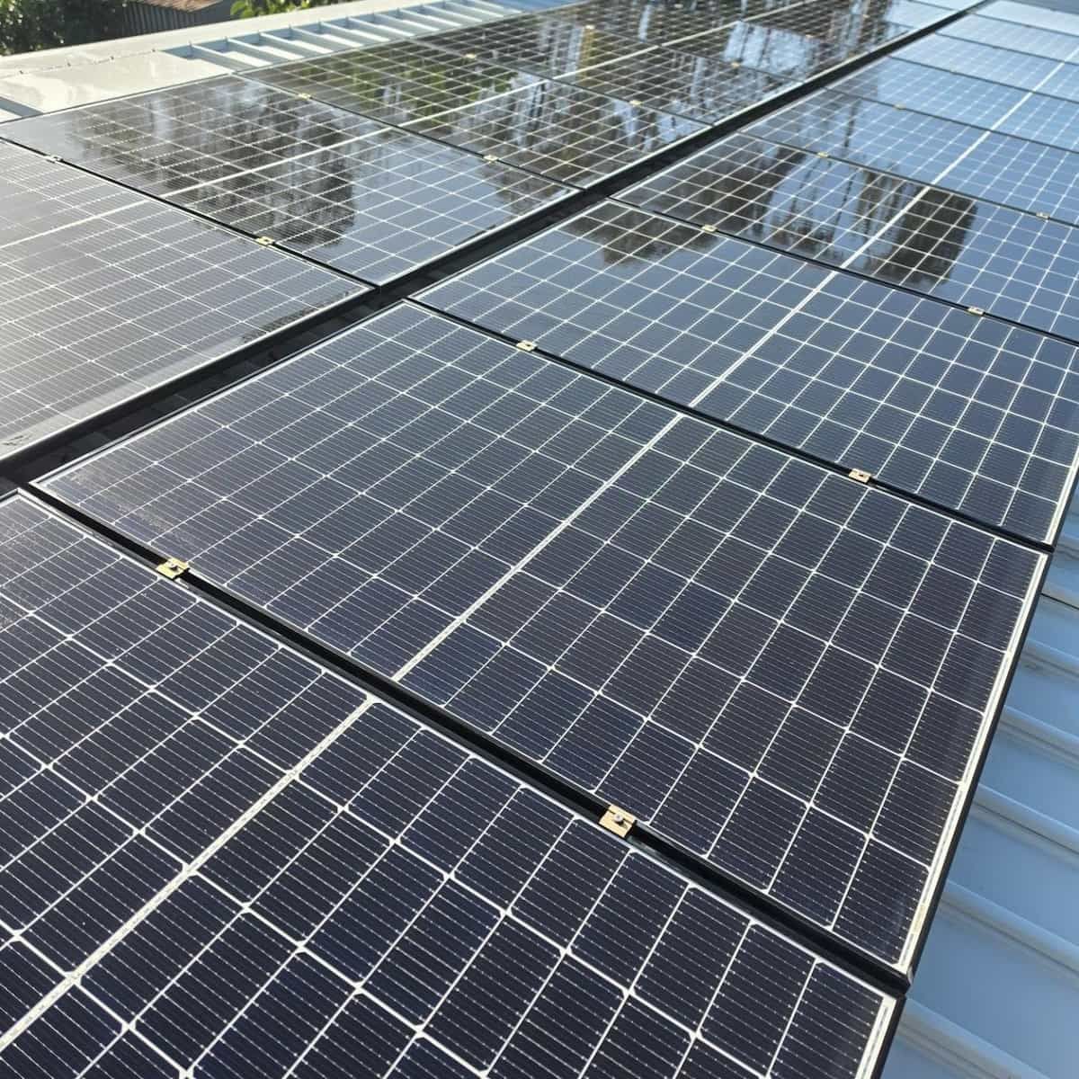 Rows of Dark Solar Panels on a Rooftop — Jervis Bay Pressure Washing & Property Maintenance in Jervis Bay, NSW