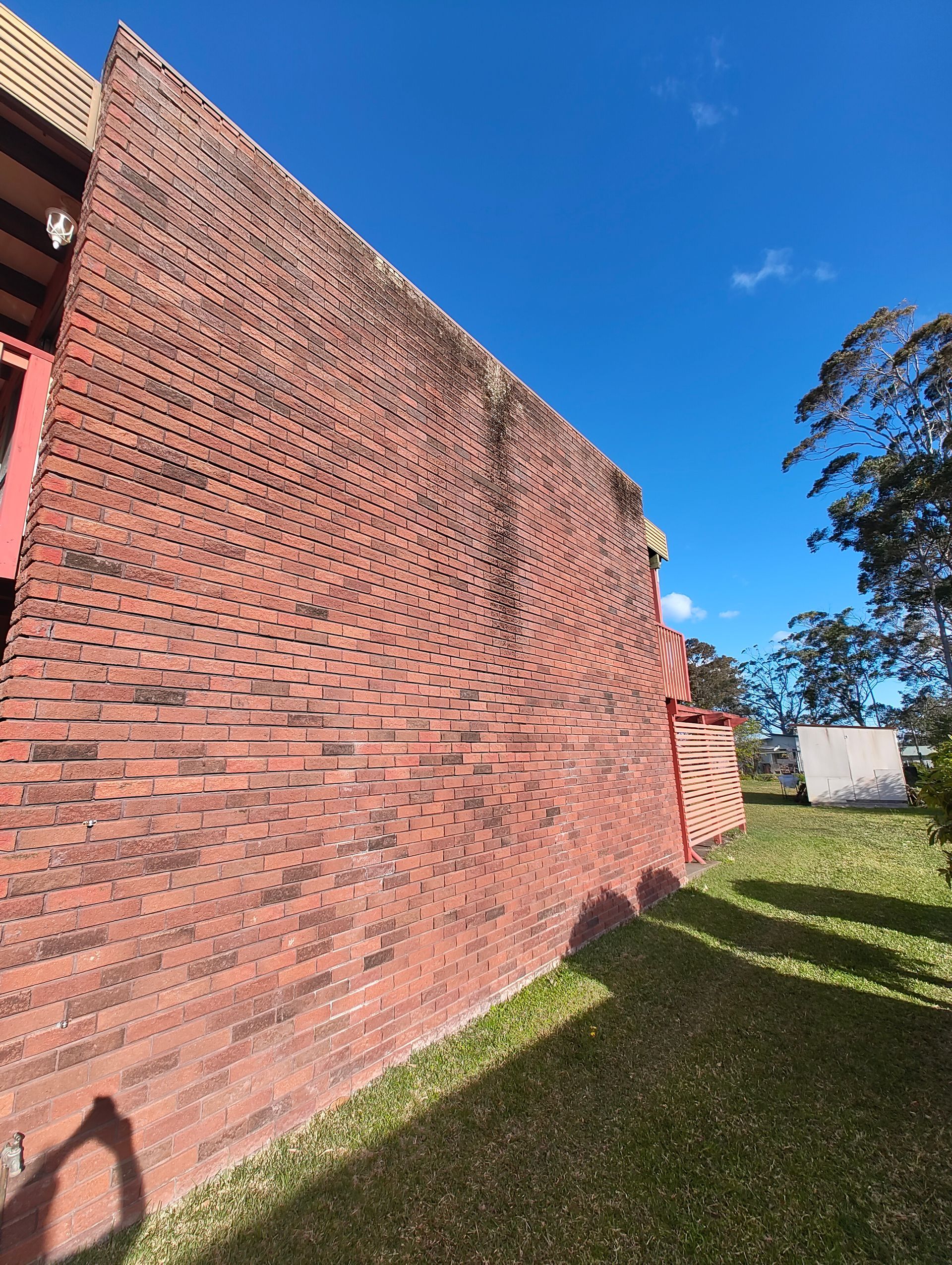 A Large Dirty Red Brick Wall — Jervis Bay Pressure Washing & Property Maintenance in Sanctuary Point, NSW