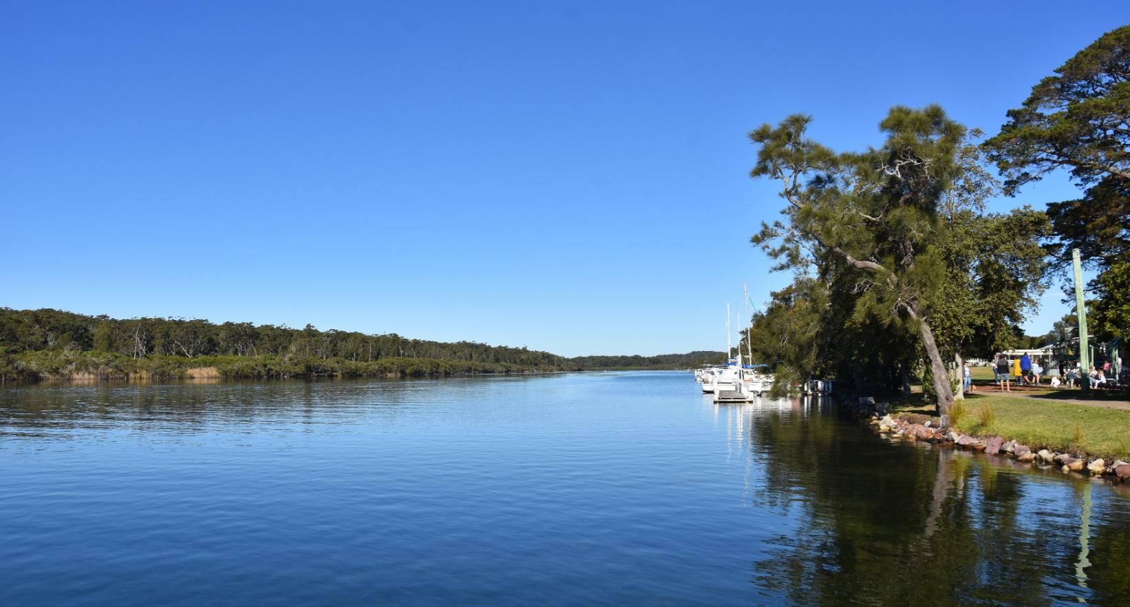 A Large Body Of Water Surrounded By Trees — Jervis Bay Pressure Washing & Property Maintenance In Sussex Inlet, NSW