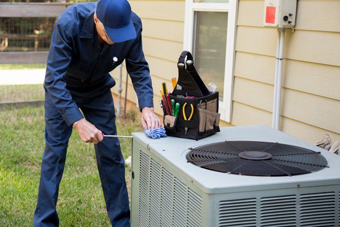 Man Fixing the Aircon — Lithia, Fl — JS Watson Air