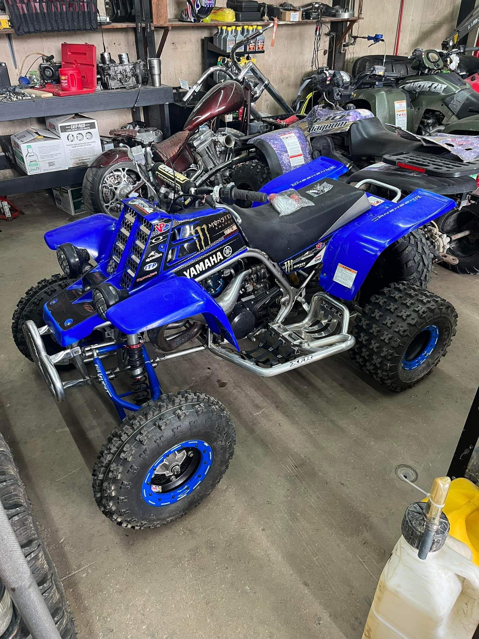 Blue ATV parked in a garage