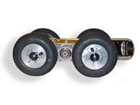 Four-wheeled robot with large, black rubber tires on a white surface.