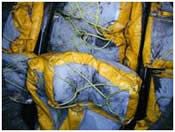 Yellow and gray protective gear, possibly hazmat suits, crumpled together.