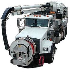 White Truck – Kalamazoo, MI – Clean Earth Environmental Contracting Services White vacuum truck with a large hose extended to the side, parked outside.