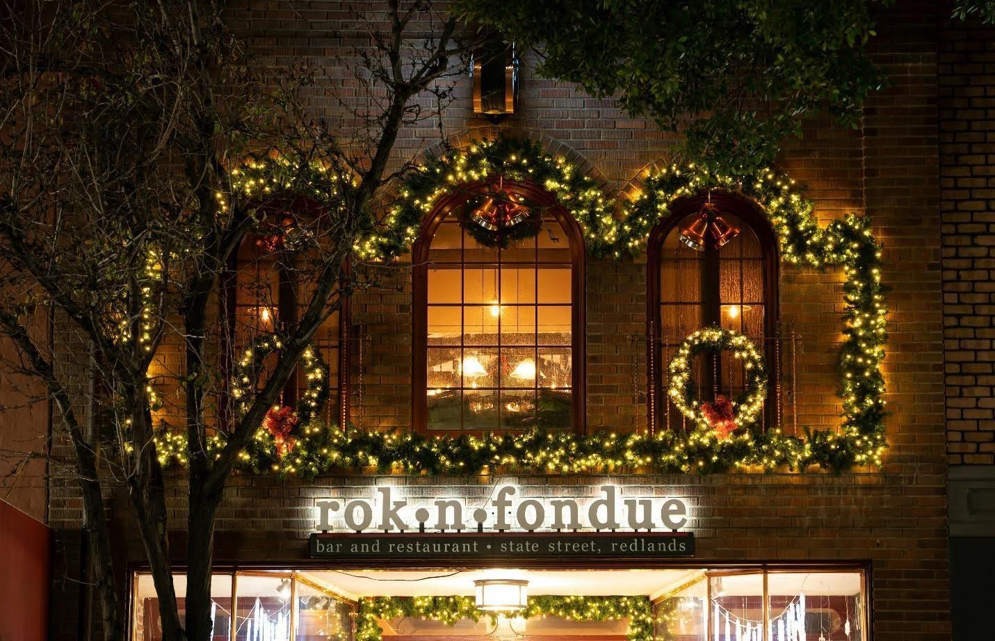 Arched windows with Christmas garlands and lights.