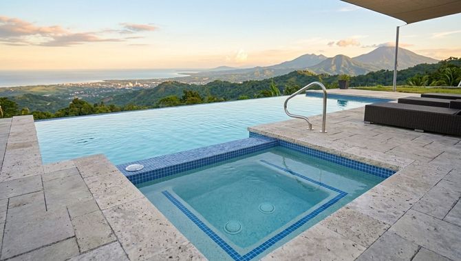 Infinity pool and hot tub overlooking a mountain valley at sunset