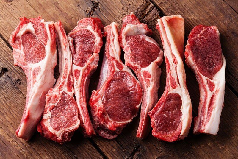 A Raw Lamb Chops on a Wooden Surface, Showing Red Meat and White Fat — Paddock to Plate in Tamworth, NSW