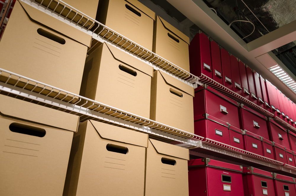 A Bunch Of Cardboard Boxes Are Stacked On Top Of Each Other — Twin Towns Removals Mid North Coast In Tuncurry, NSW