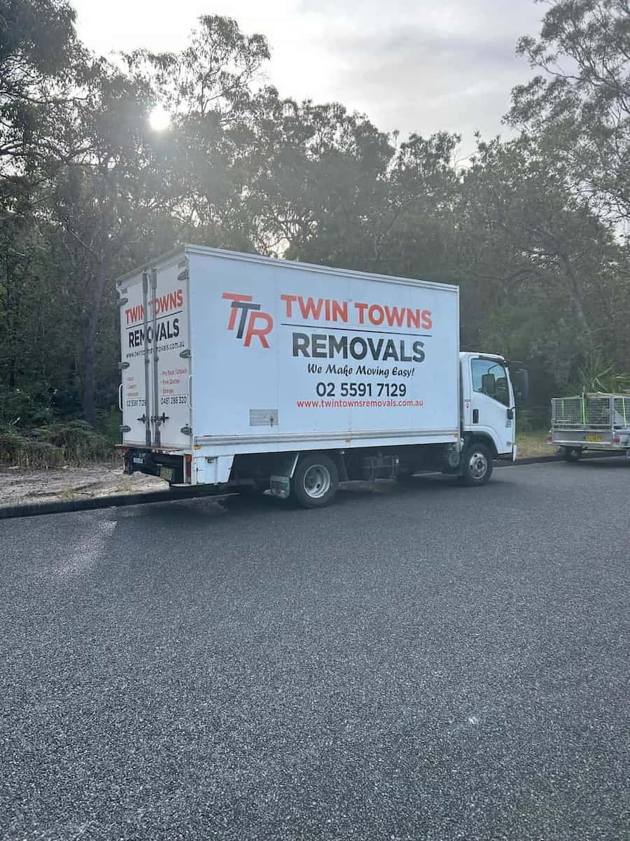 A Moving Truck Is Parked On The Side Of The Road — Twin Towns Removals Mid North Coast In Tuncurry, NSW