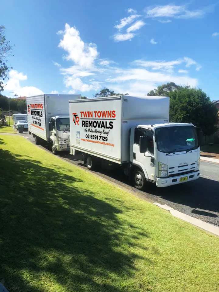 Two White Removal Trucks Parked Next To Grass — Twin Towns Removals Mid North Coast In Tuncurry, NSW