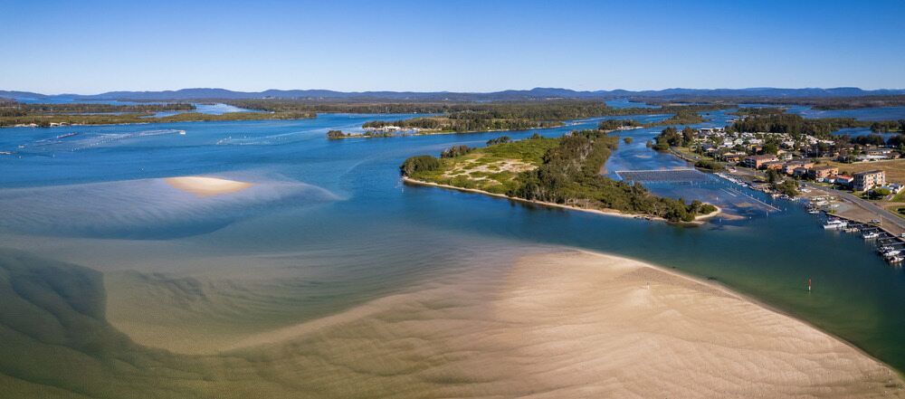 An Aerial View Of A Body Of Water With A Small Island In The Middle — Twin Towns Removals Mid North Coast In Tuncurry, NSW