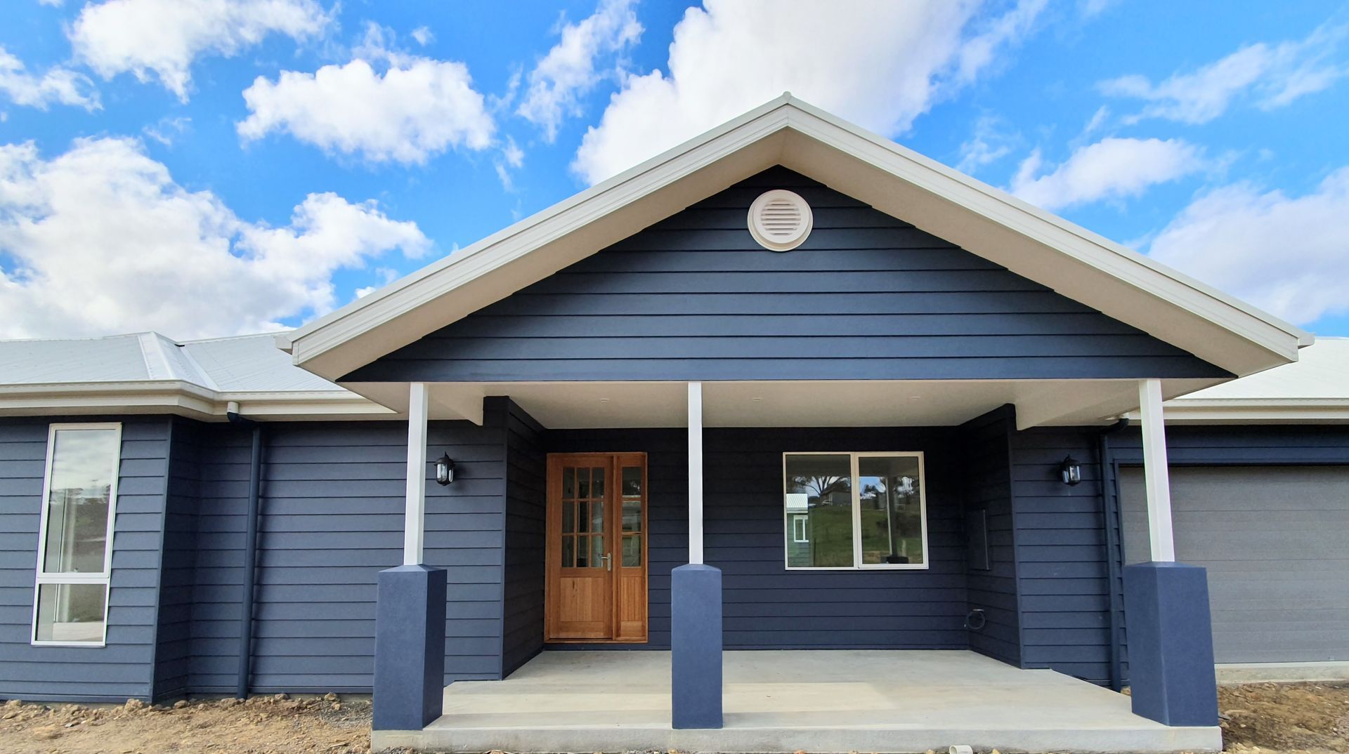 a freshly painted blue and white house — Crampton Painting & Decorating Pty Ltd In Maiden Gully, VIC