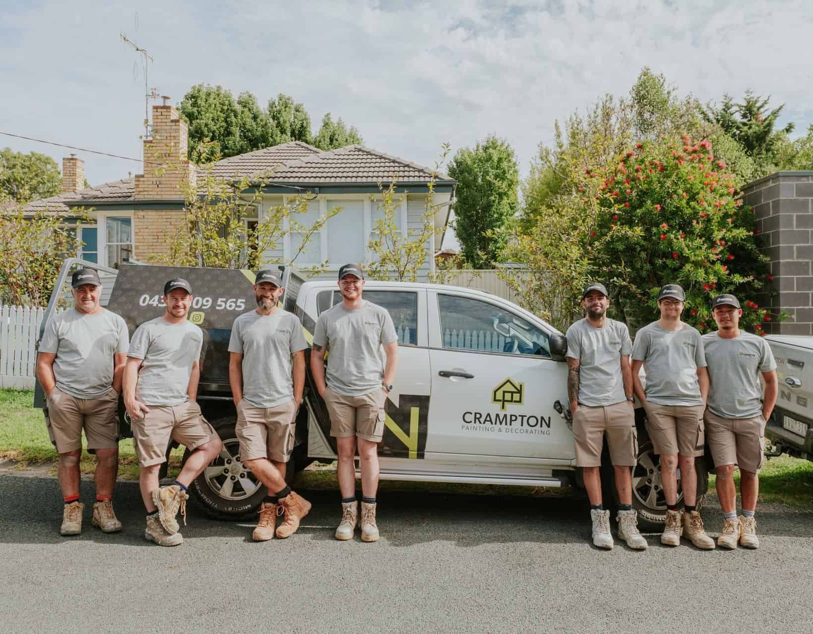 A Group Of Men Are Working On A Brick Building — Crampton Painting & Decorating Pty Ltd In Maiden Gully, VIC