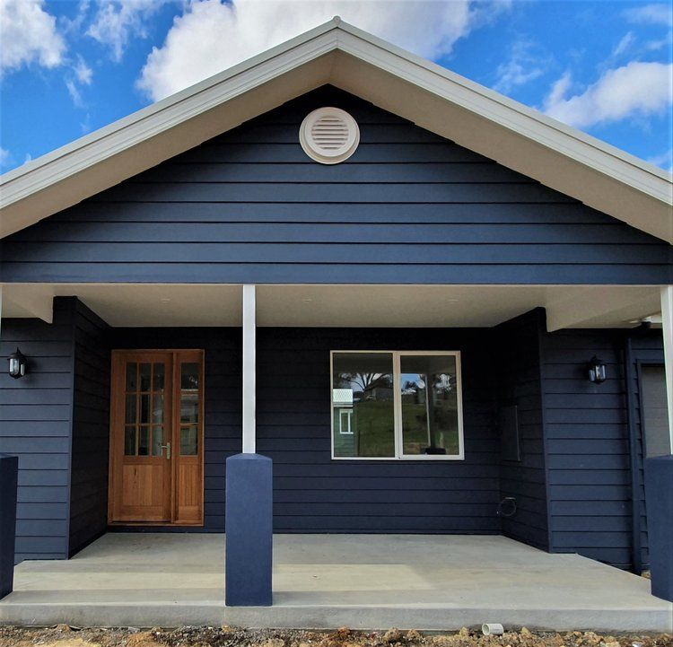 The Front Of A Black House With A Porch — Crampton Painting & Decorating Pty Ltd In Maiden Gully, VIC