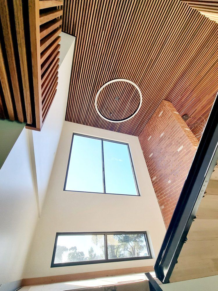 Looking Up At The Ceiling Of A Room With A Circular Light Hanging From It — Crampton Painting & Decorating Pty Ltd In Maiden Gully, VIC