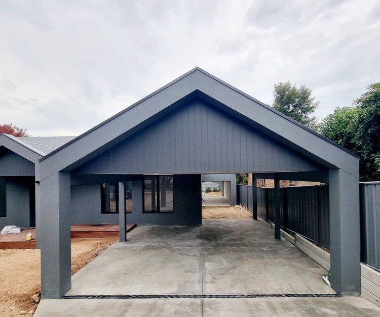 A Gray House With A Carport Underneath It — Crampton Painting & Decorating Pty Ltd In Maiden Gully, VIC
