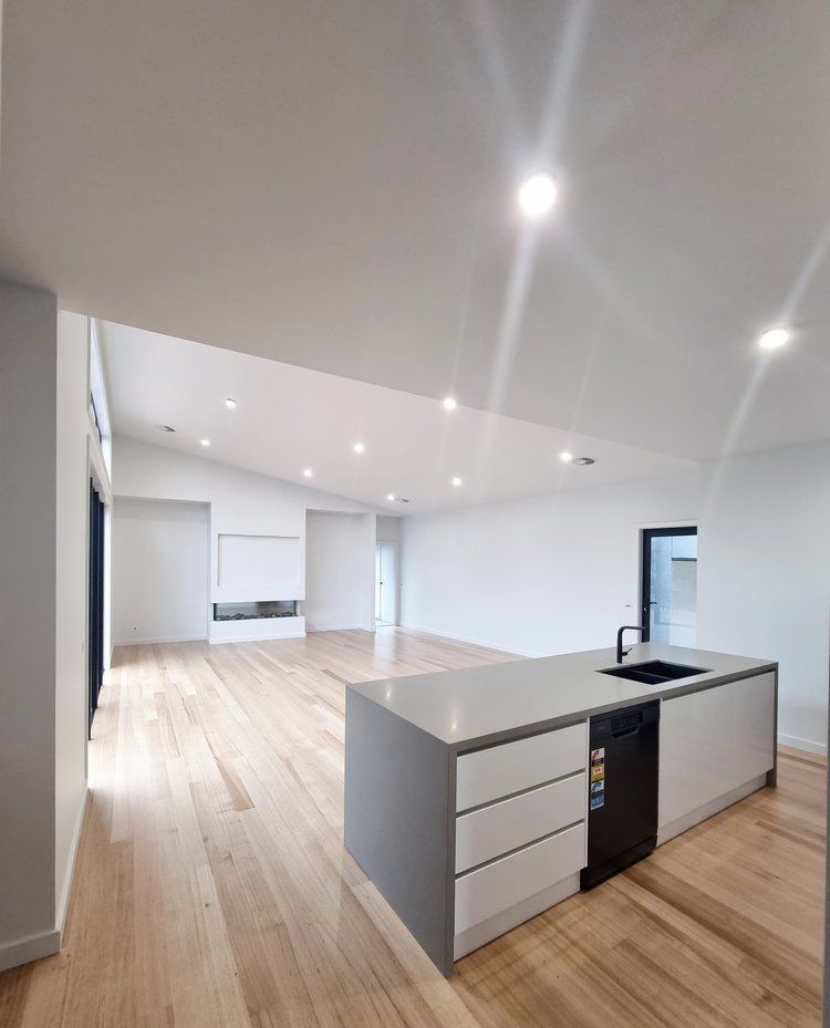 A Kitchen With A Large Island In The Middle Of The Room — Crampton Painting & Decorating Pty Ltd In Maiden Gully, VIC