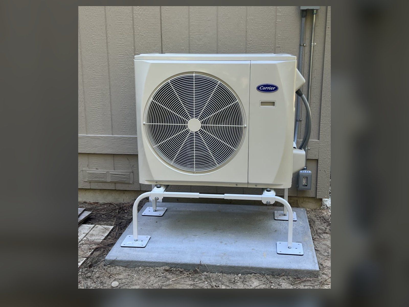 New Carrier ductless outdoor unit on a raised stand and concrete pad, installed by Alpine Aire at a home in Leavenworth, WA