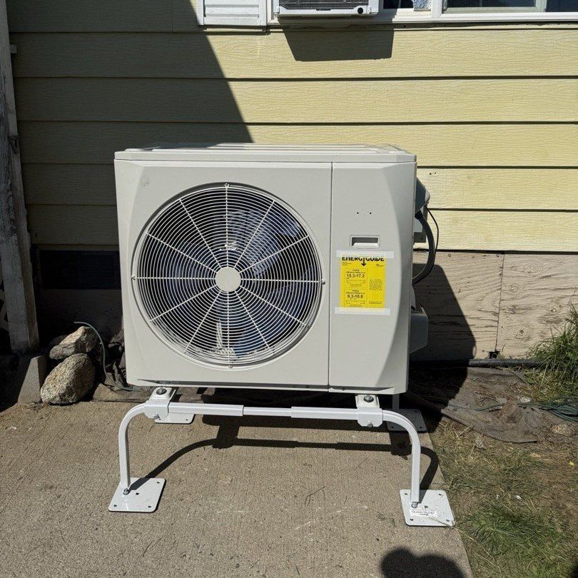 Heat pump outdoor unit installed by Alpine Aire on a raised stand beside a home in Cashmere, WA