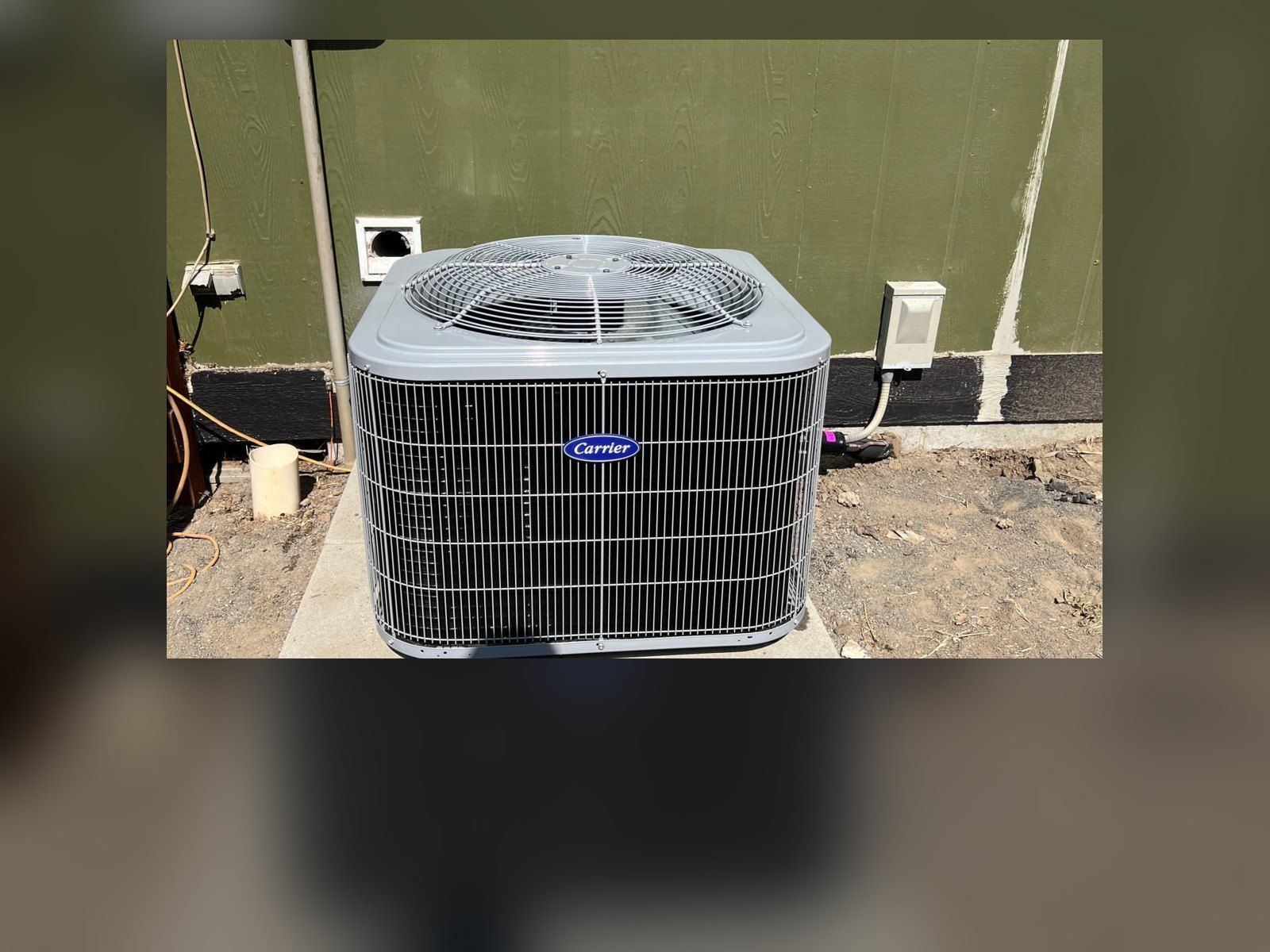 New Carrier heat pump on a concrete pad, installed by Alpine Aire at a home in Quincy, WA